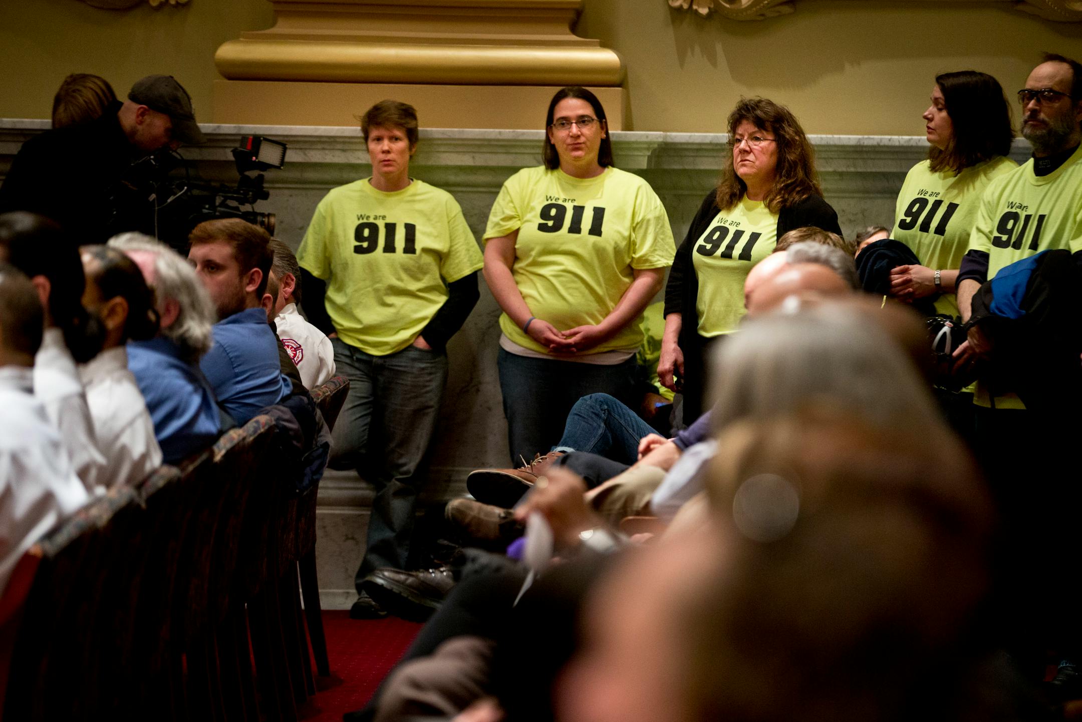 Michelle Swenson, Kari Pflaum and Wendy Forster stood frustrated with fellow 911 dispatch colleagues during a presentation about Minneapolis 911's cross training initiative on Wednesday. The employees felt they were being misrepresented and didn't agree with some of the statements made.