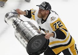 Pittsburgh Penguins' Patric Hornqvist (72), of Sweden, hoists the Stanley Cup after defeating Nashville Predators in Game 6 of the NHL hockey Stanley 