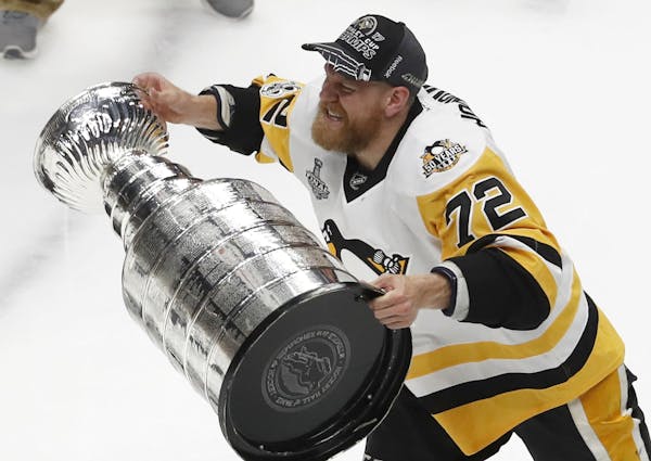 Pittsburgh Penguins' Patric Hornqvist (72), of Sweden, hoists the Stanley Cup after defeating Nashville Predators in Game 6 of the NHL hockey Stanley 