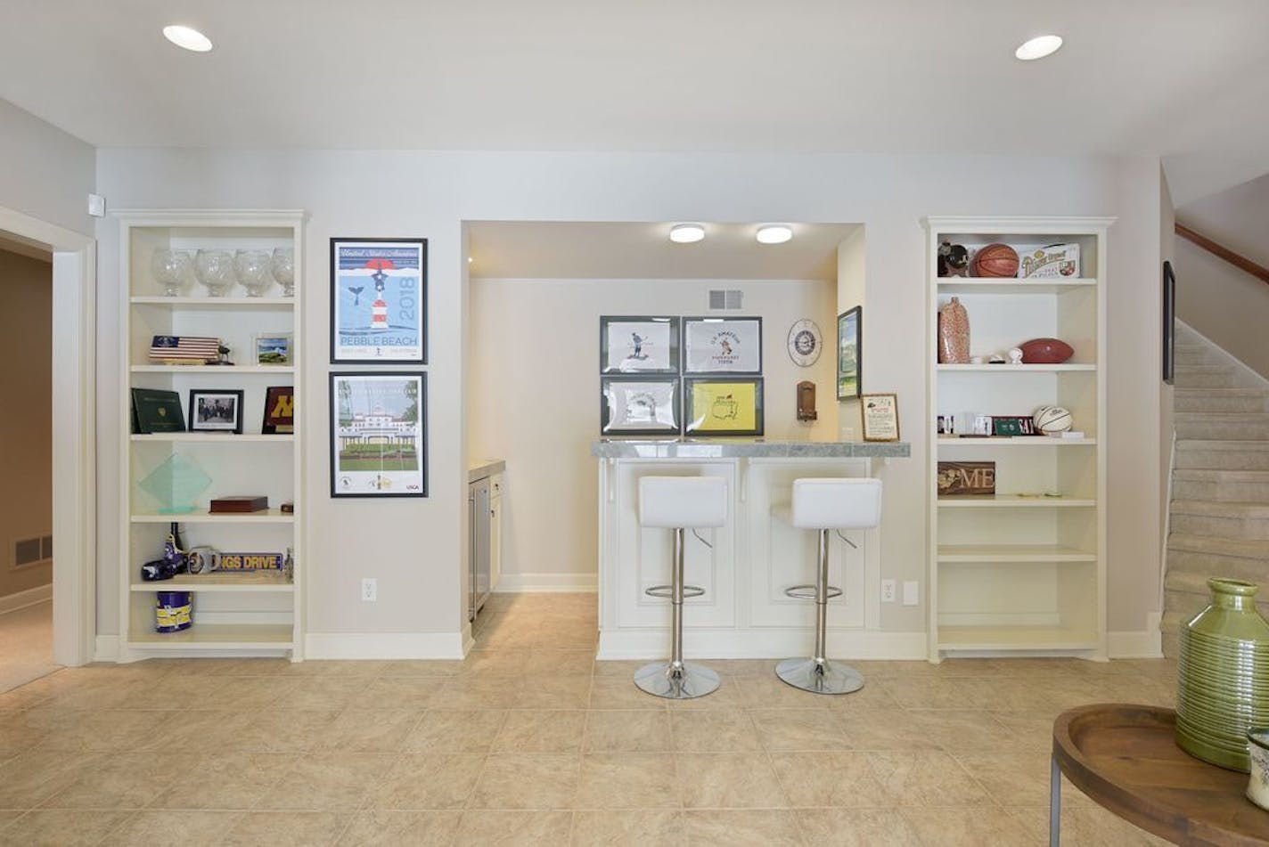 The walkout lower level features a two-sided fireplace, a bar and an impressive collection of framed sports jerseys.