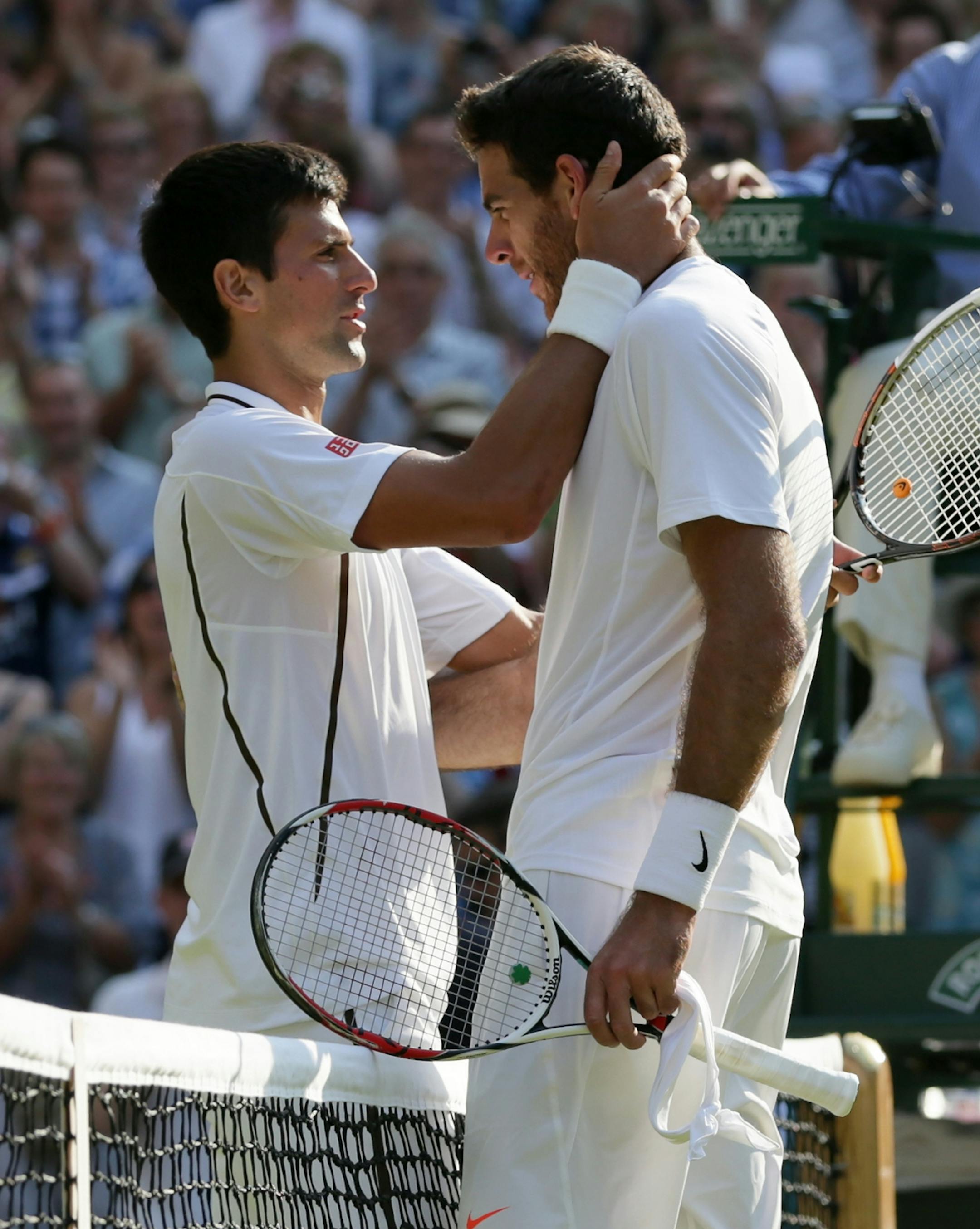 Novak Djokovic of Serbia, left, speaks with Juan Martin Del Potro of Argentina after defeating him in their Men's singles semifinal match at the All England Lawn Tennis Championships in Wimbledon, London, Friday, July 5, 2013.