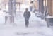 A pedestrian walks down S. 9th St. while high winds kick up snow Thursday, Dec. 22, 2022 in downtown Minneapolis. The Twin Cities saw 8 inches of snow