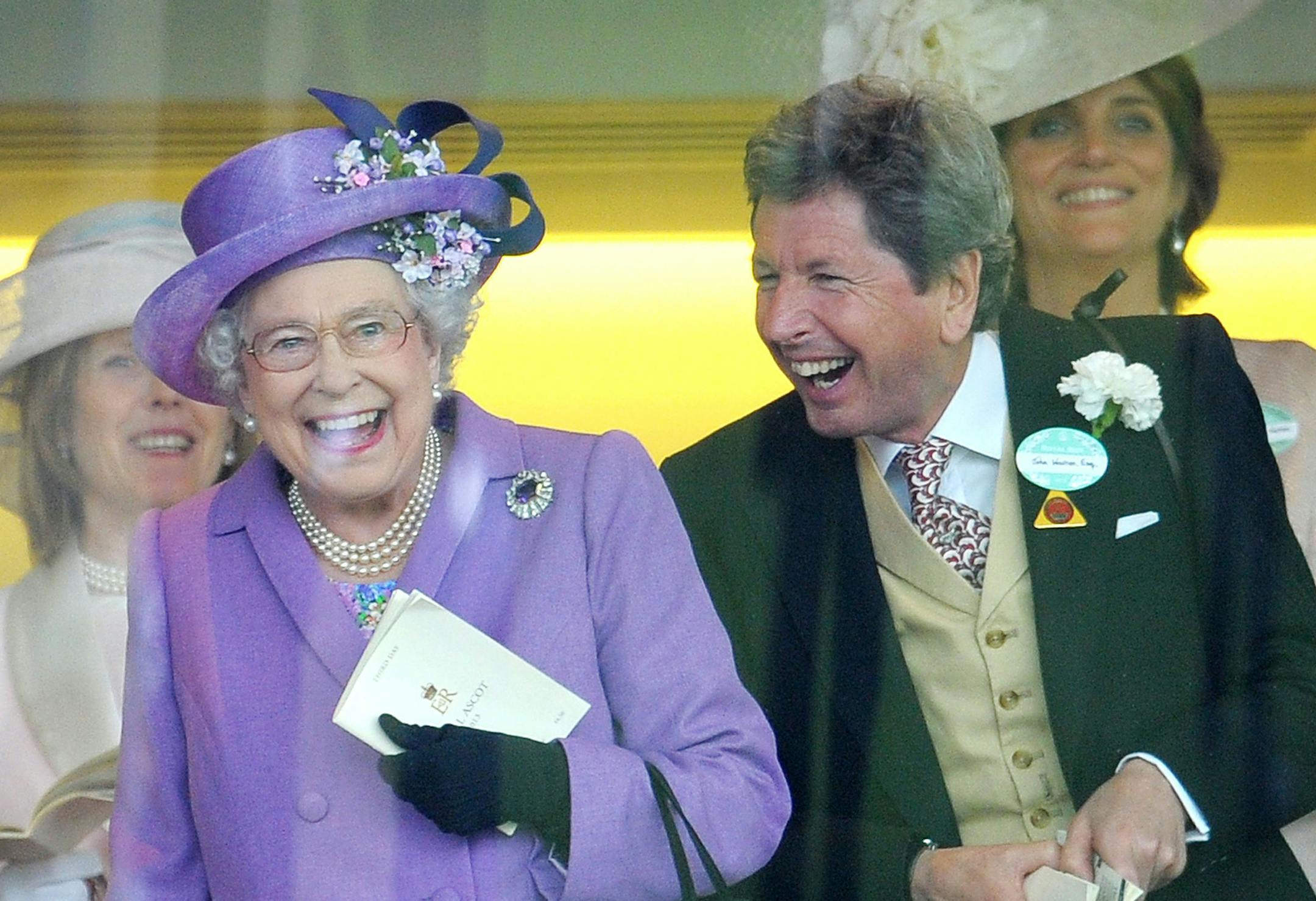 Britain's Queen Elizabeth II with her racing manager John Warren react after her horse, Estimate, won the Gold Cup on day three of the Royal Ascot meeting at Ascot Racecourse, England, Thursday June 20, 2013. (AP Photo / Tim Ireland/PA) UNITED KINGDOM OUT NO SALES NO ARCHIVE