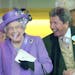 Britain's Queen Elizabeth II with her racing manager John Warren react after her horse, Estimate, won the Gold Cup on day three of the Royal Ascot mee