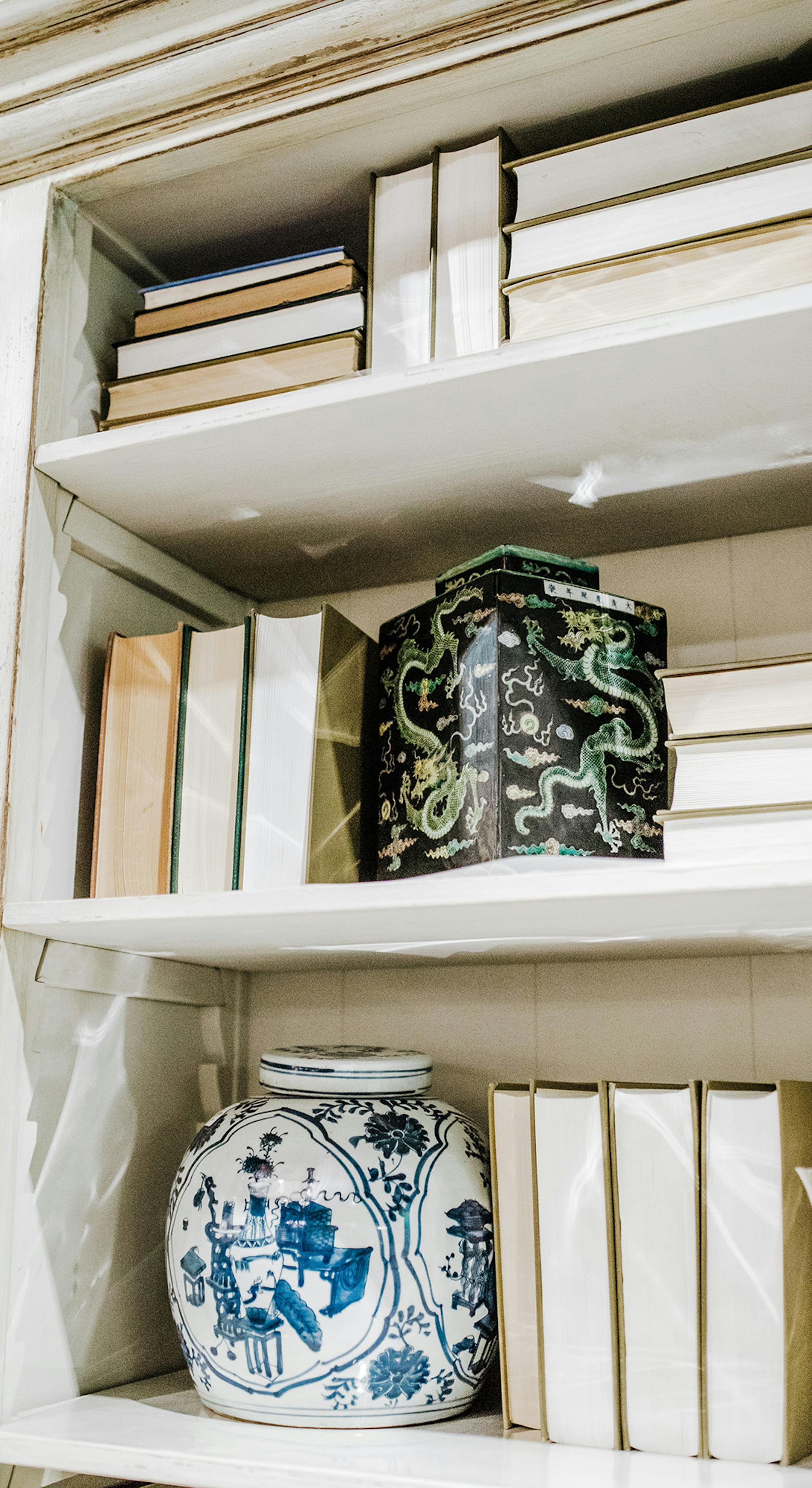 While not a look for everyone, if you want a neutral background for your shelf, you can turn your books around to create a blank canvas.