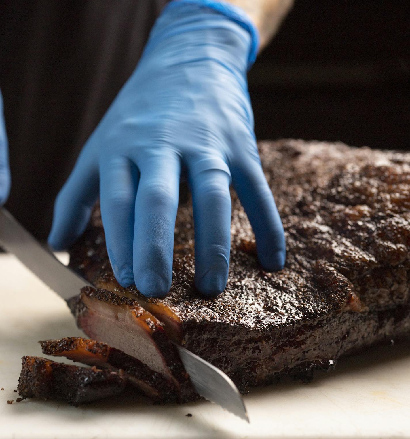 JEFF WHEELER • jeff.wheeler@startribune.com Kale Thome sliced a Revier Farms brisket fresh from the smoker at Minnesota Barbecue Co.