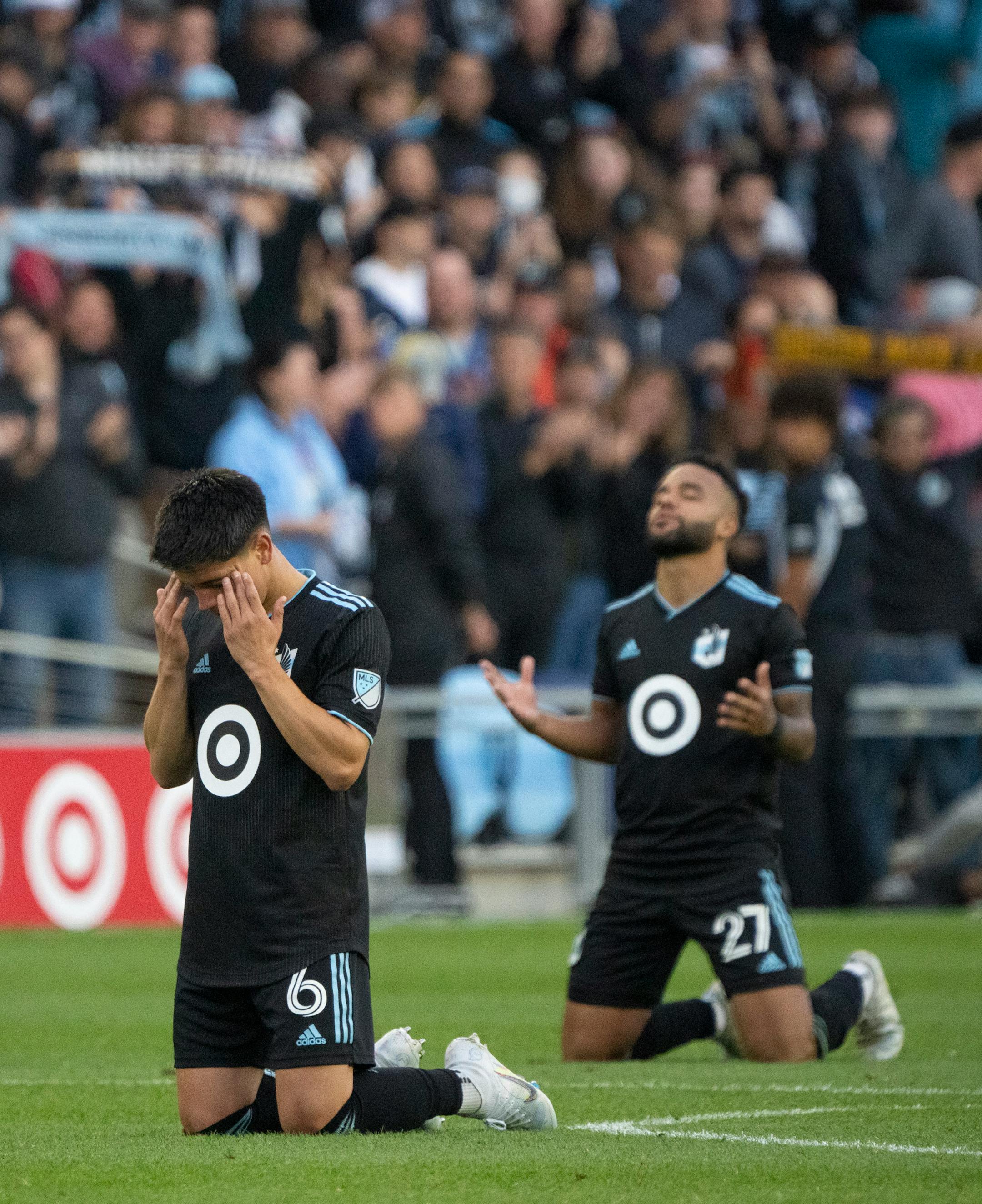 Minnesota United midfielder Jonathan Gonzalez (6) and teammate defender D.J. Taylor (27) dropped to their knees in thanks after the Loons won to advance to the playoffs.