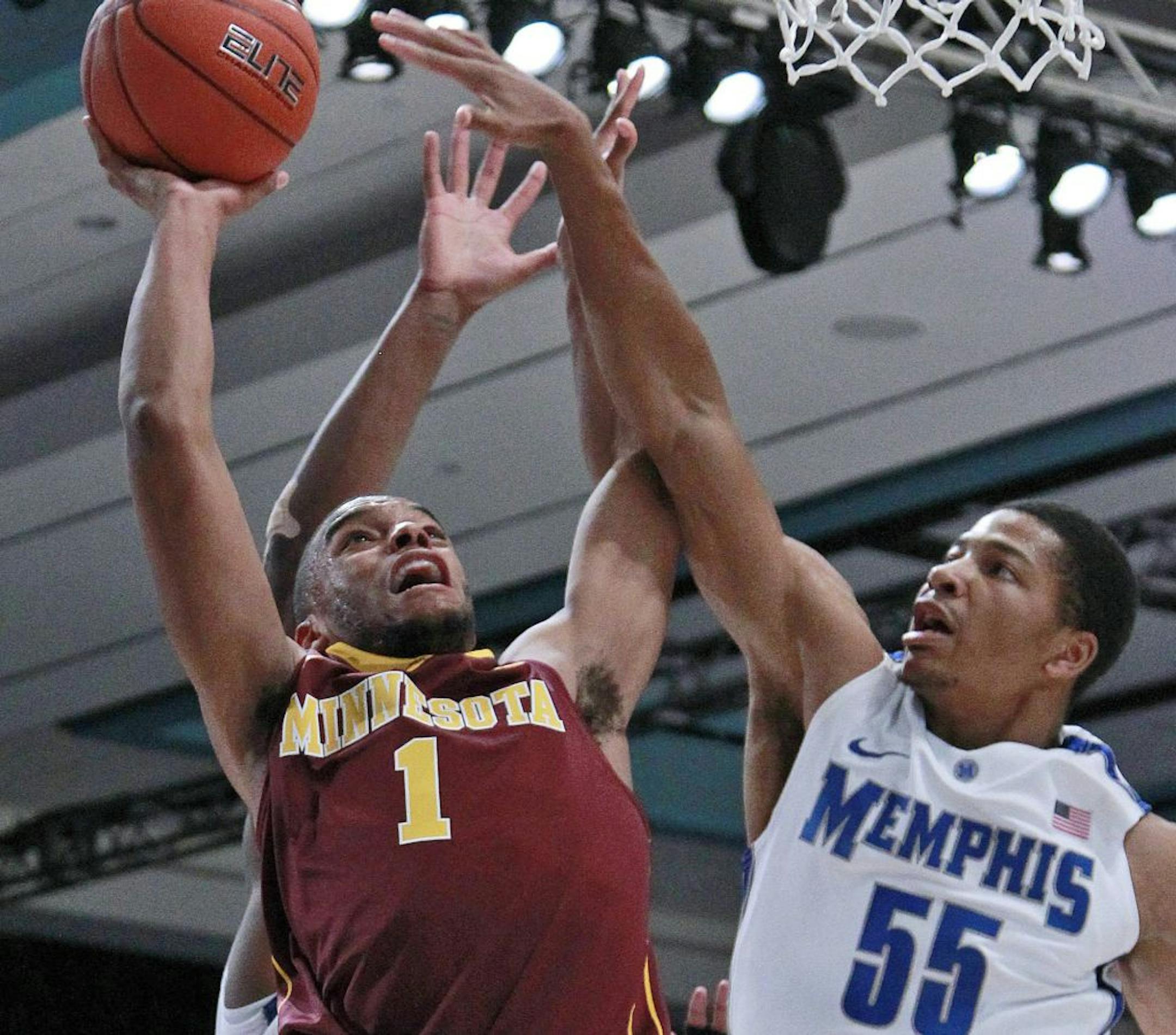 Minnesota guard Andre Hollins (1) goes to the basket as Memphis guard Geron Johnson (55) defends during the first half of an NCAA college basketball game at the Battle 4 Atlantis tournament, Friday, Nov. 23, 2012 in Paradise Island, Bahamas. (AP Photo/John Bazemore) ORG XMIT: MIN2012112314265634