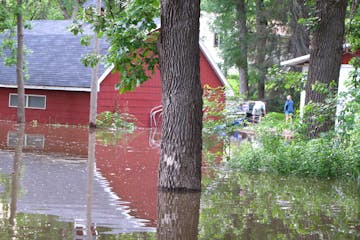 The swollen Mississippi River overwhelmed the levee in Newport, inundating several buildings and homes. The city declared a state of emergency last we