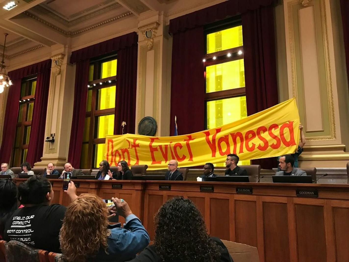 Supporters of tenants of former properties owned by embattled landlord Stephen Frenz unfurled a banner reading "Don't Evict Vanessa" behind the Minneapolis City Council on May 3, 2019. They were soon asked to move from behind the dias.