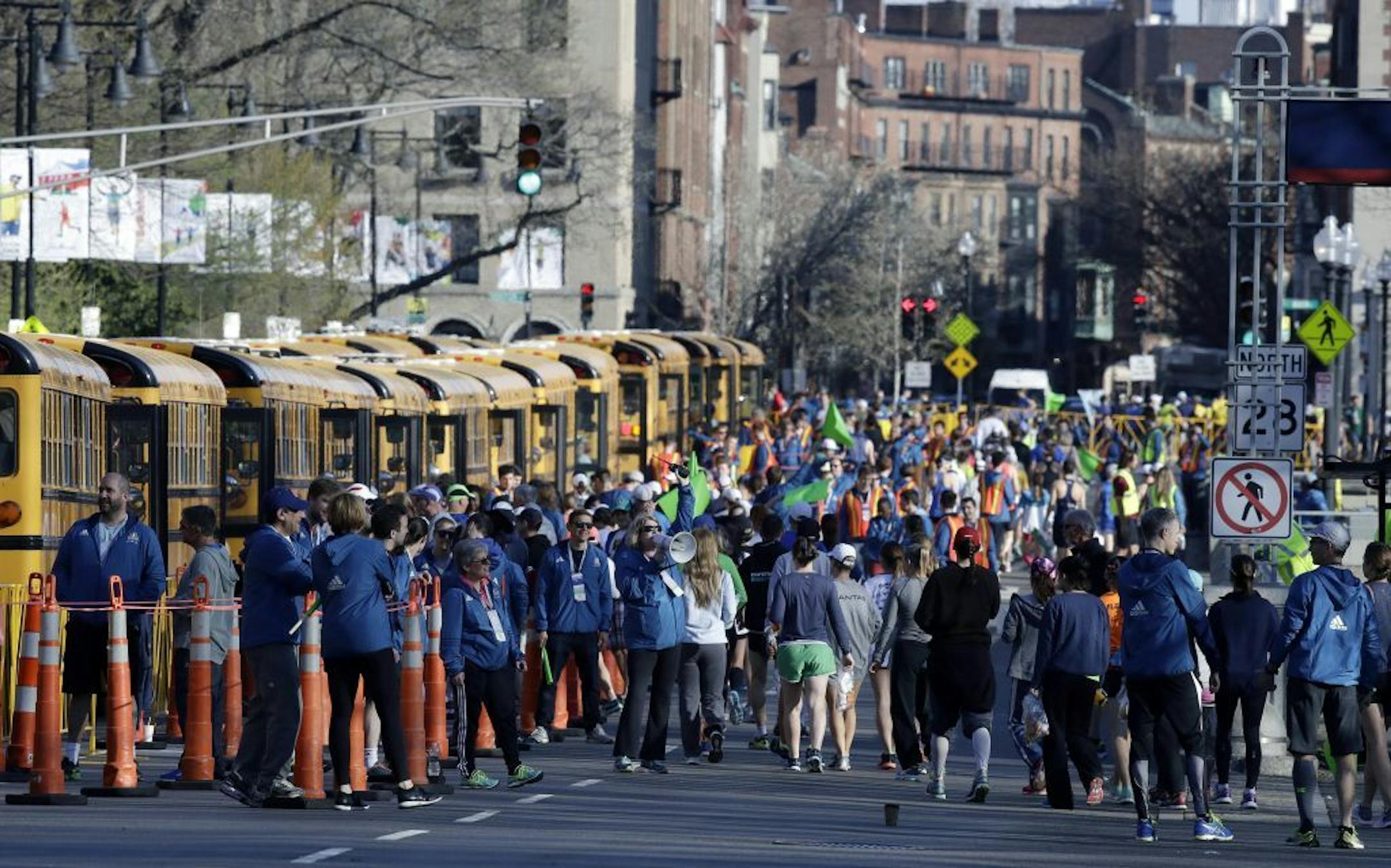 Runners gather in Boston to board buses for the starting line in Hopkinton, Mass., for 121st Boston Marathon on Monday, April 17, 2017.