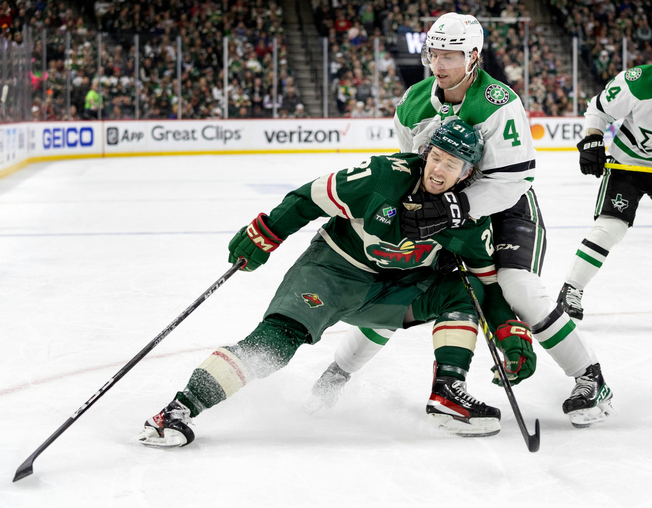 Brandon Duhaime (21) of the Minnesota Wild and Miro Heiskanen (4) of the Dallas Stars in the first period.