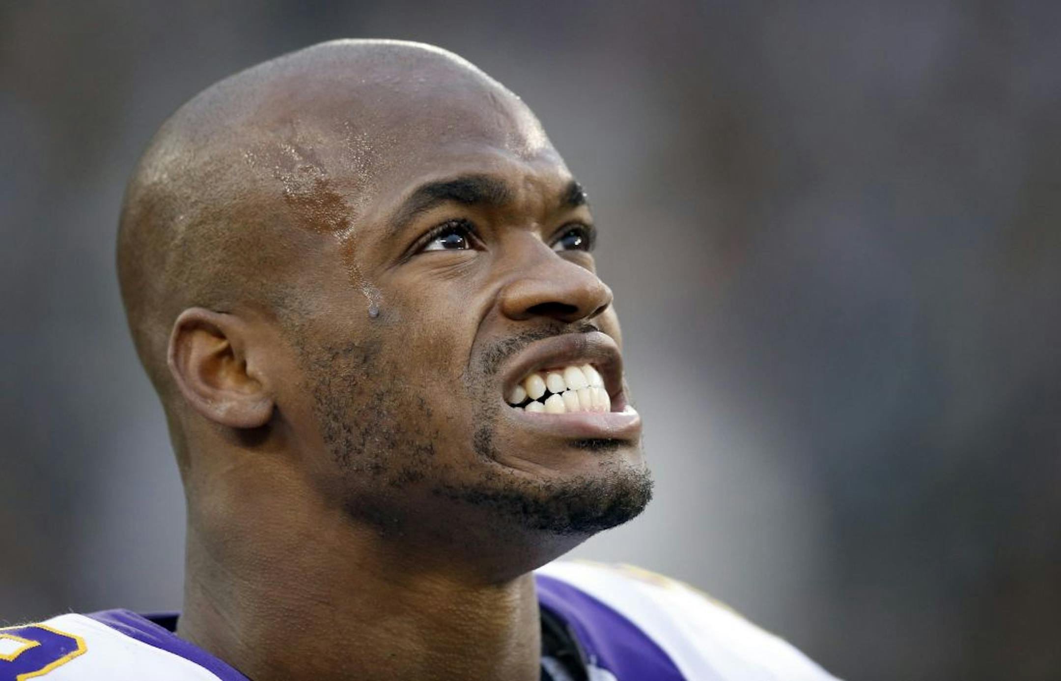 Vikings running back Adrian Peterson grimaced on the sidelines after a missed field goal by Blair Walsh late in the fourth quarter. Peterson has 210 yards rushing in the 23-14 loss to Green Bay.