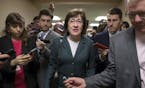 FILE- In this Nov. 30, 2017, file photo, with reporters looking for updates, Sen. Susan Collins, R-Maine, and other senators rush to the chamber to vo