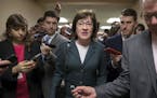 FILE- In this Nov. 30, 2017, file photo, with reporters looking for updates, Sen. Susan Collins, R-Maine, and other senators rush to the chamber to vo