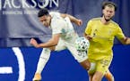 Minnesota United midfielder Hassani Dotson (31) and Nashville defender Walker Zimmerman (25) chase down the ball during the second half of an MLS socc