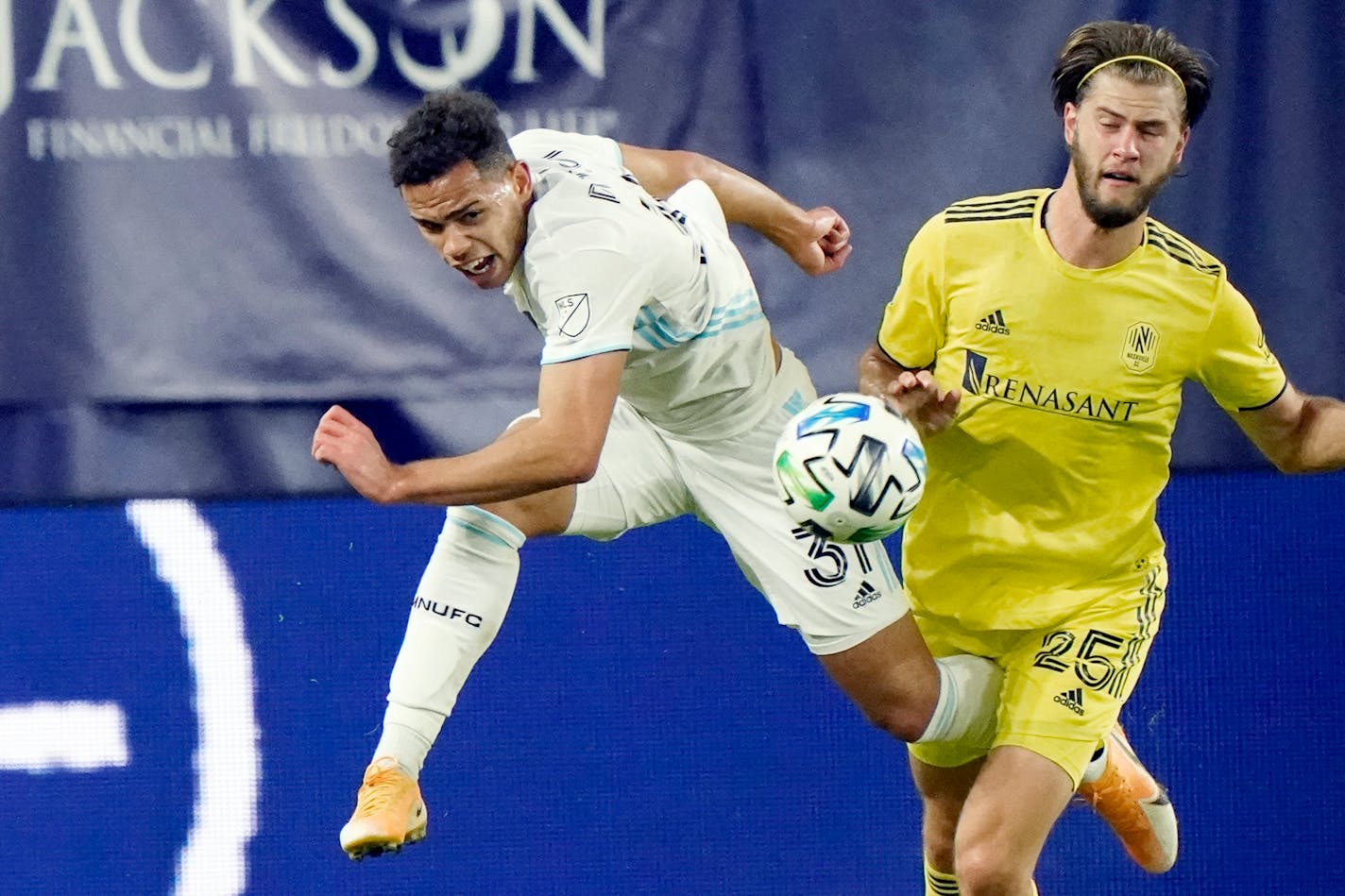 Minnesota United midfielder Hassani Dotson (31) and Nashville defender Walker Zimmerman (25) chase down the ball during the second half of an MLS soccer match Tuesday, Oct. 6, 2020, in Nashville, Tenn. (AP Photo/Mark Humphrey)