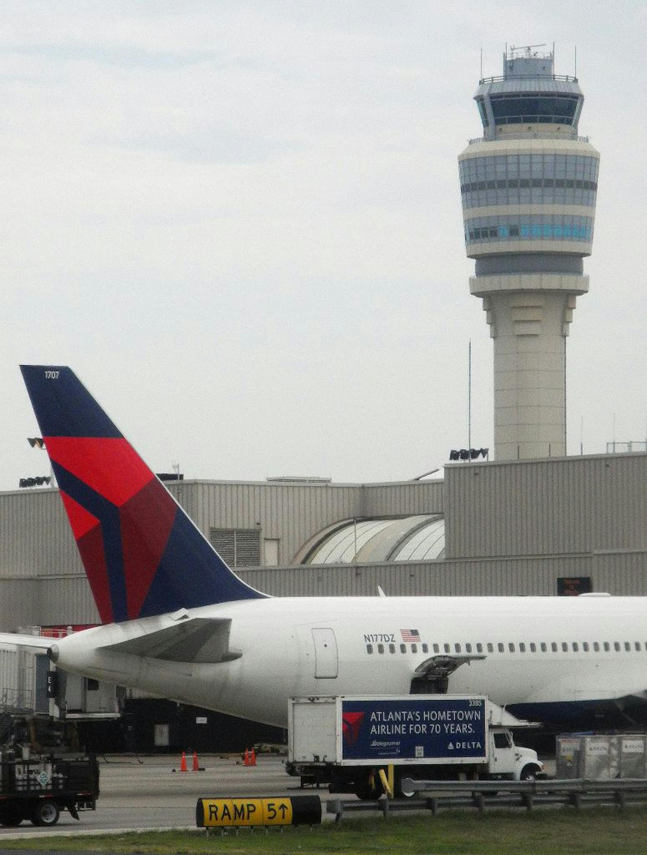 In this Thursday, Aug 4, 2011 photo, a Delta Airlines plane sits at a jetway at Hartsfield-Jackson Atlanta International Airport, in Atlanta. Delta Air Lines Inc. says it expects an $800 million profit this year, and it will be solidly profitable in 2012. The company says in a filing that it will earn $1.1 billion in 2011 if special items are excluded.