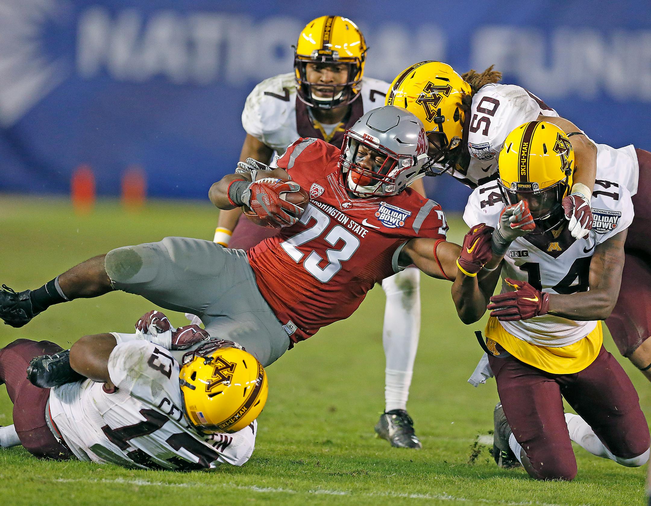 Minnesota's defense took down Washington State's running back Gerard Wicks during the fourth quarter as they took on Washington State at Qualcomm Stadium for the San Diego Holiday Bowl, Tuesday, December 27, 2016 in San Diego, CA.