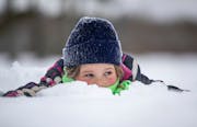 Georgia Carpenter, 7, played in the snow while her older sister, Claire, ran in the John Beargrease Cub Run last month in Two Harbors.There's a fresh 