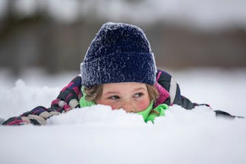 Georgia Carpenter, 7, played in the snow while her older sister, Claire, ran in the John Beargrease Cub Run last month in Two Harbors.There's a fresh 