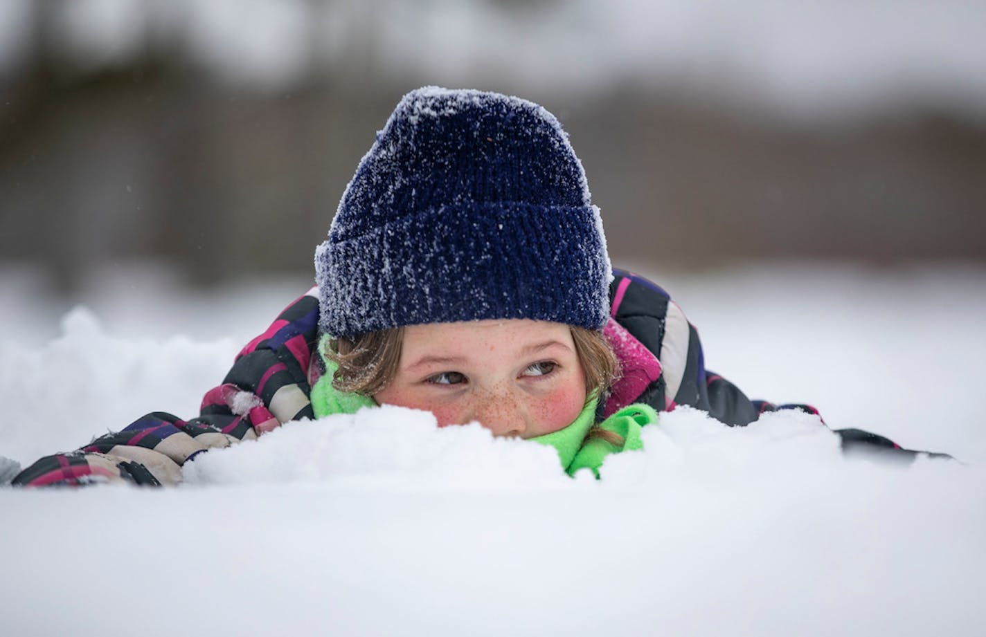 Georgia Carpenter, 7, played in the snow while her older sister, Claire, ran in the John Beargrease Cub Run last month in Two Harbors.There's a fresh batch of snow on the way.