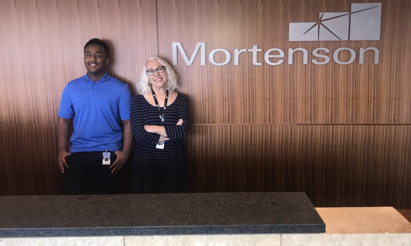 Suleyman Osman, left,one of 300-plus high school interns placed annually by workforce-development nonprofit Genesys Works of St. Paul, works at M.A. Mortenson Co. He is shown here with supervisor Katrena Proffitt. (Provided photo)