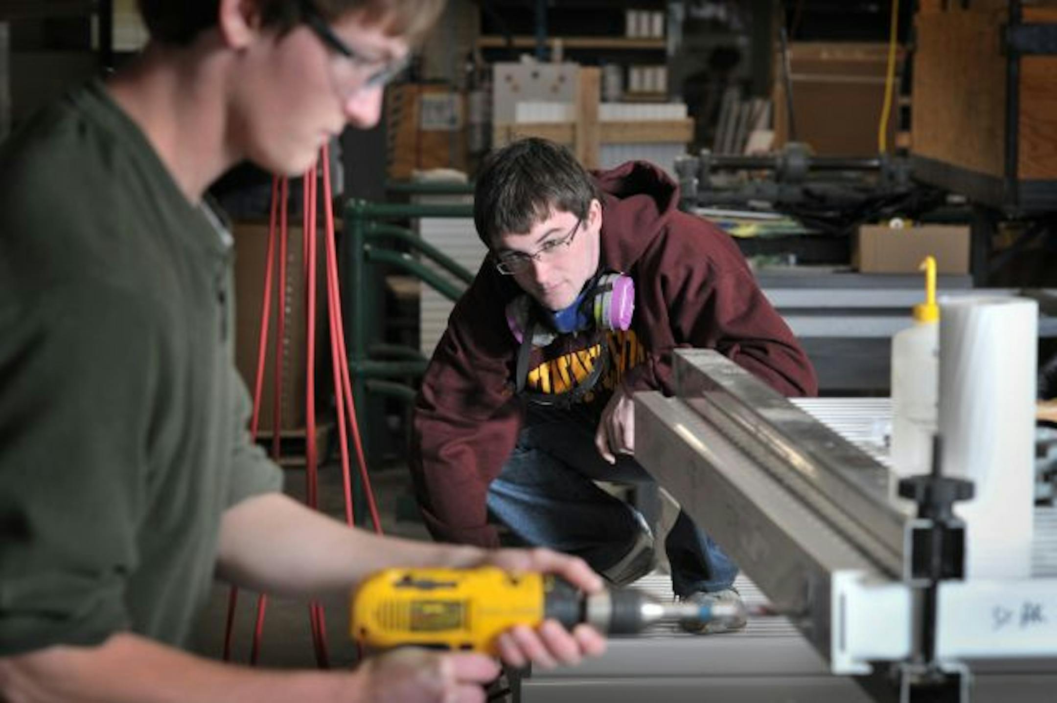 University of Minnesota students Joshua Sleper, left, and Matt Norton, right, work on neutrino-sensing panels that will be filled with oil and fiber-optic cables to detect neutrinos. The panels will be buried at a site in Ash River, Minnesota and detect neutrinos fired from the Fermilab in Batavia, Illinois, near Chicago.