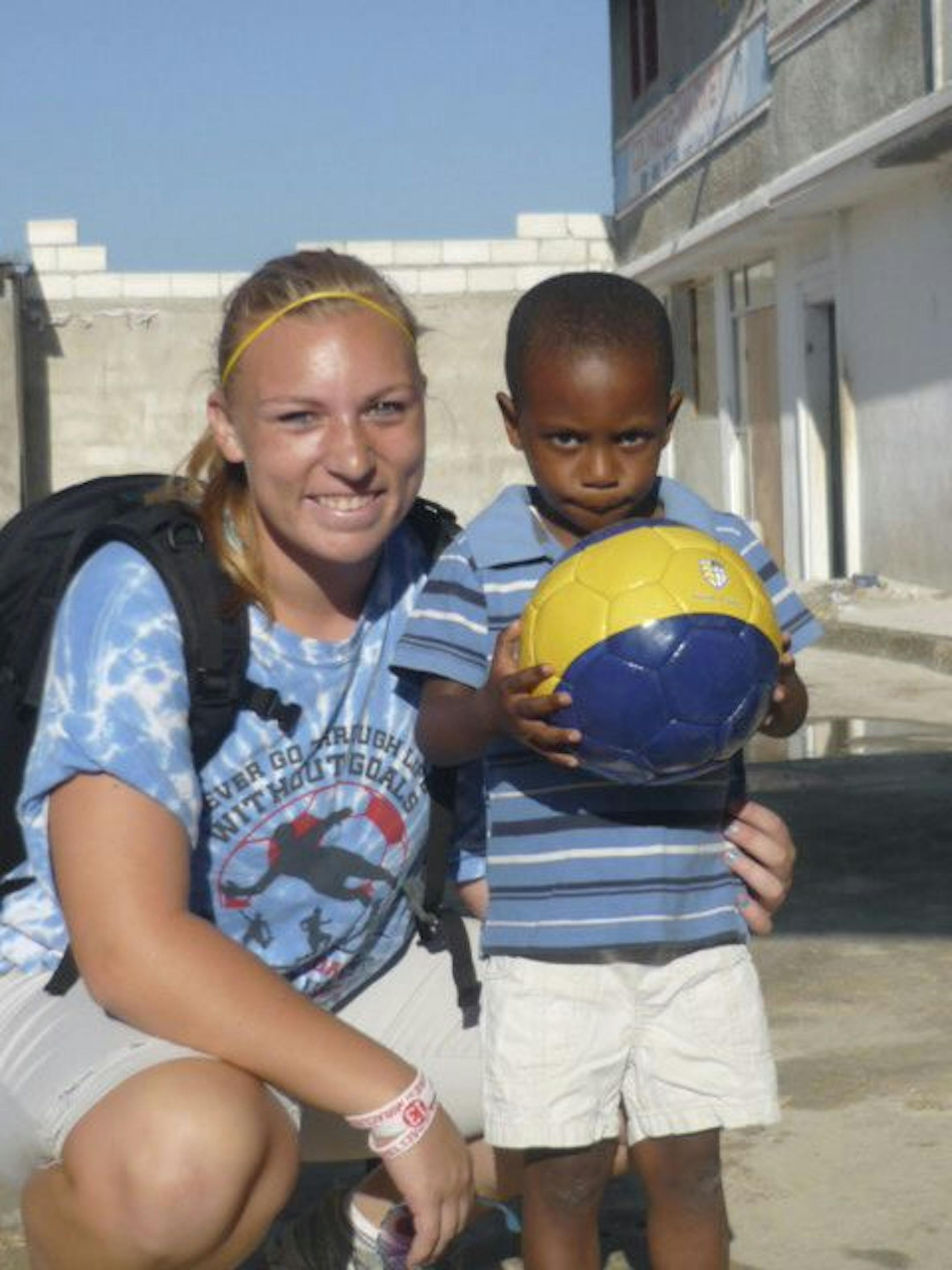 Provided by Claire Frances BakerClaire Frances Baker, "The Shoe Collector," in Haiti with friend Marvin, 4, with a soccer ball she gave him from her school.
