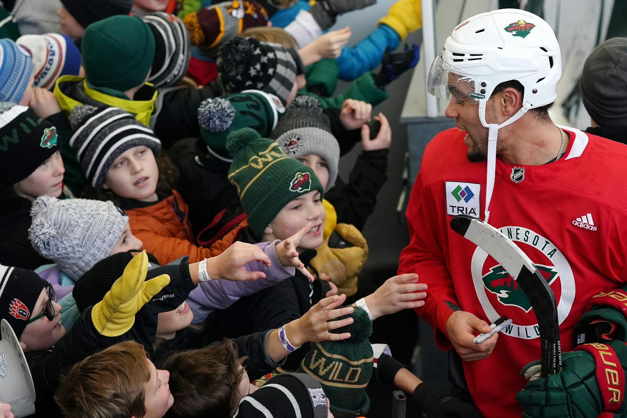 Minnesota Wild left wing Jordan Greenway (18) signed autographs following the Wild's outdoor practice Thursday.