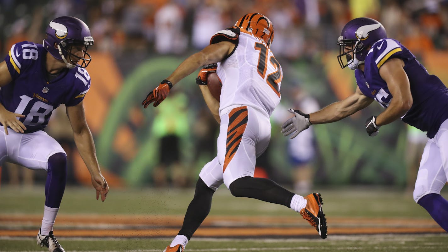 Cincinnati Bengals wide receiver Alex Erickson (12) eluded Vikings punter Jeff Locke (18) and special teams member Isaac Fruechte (15) before returning a punt in the fourth quarter 80 yards for a touchdown Friday night in Cincinnati. The Bengals failed to convert a two point try. ] JEFF WHEELER &#xef; jeff.wheeler@startribune.com The Minnesota Vikings eked out a 17-16 win over the Cincinnati Bengals in their first game of the NFL preseason Friday night, August 12, 2016 at Paul Brown Stadium in C