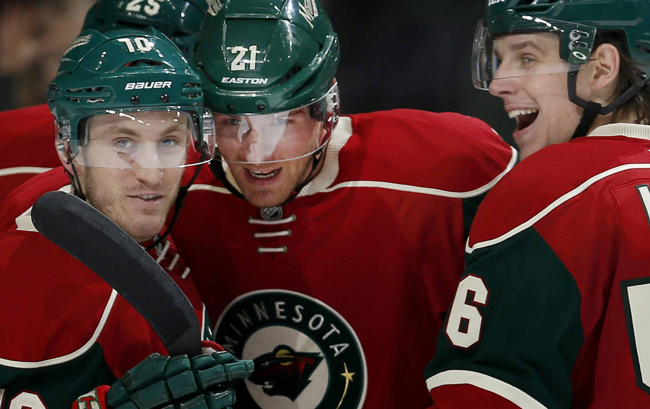 Kyle Brodziak, center, celebrated with Jordan Schroeder, right, and Erik Haula after scoring a goal in the second period to give the Wild a 5-2 lead over Vancouver.