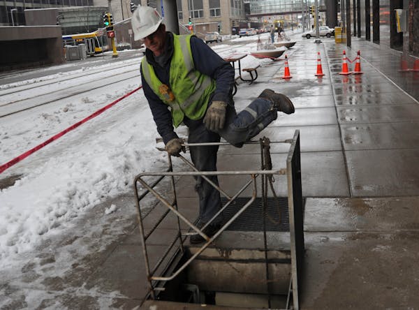 Minnesota utility regulators on Thursday approved a novel $17.5 million plan to aid Xcel's most indebted customers, File photo of an Xcel worker in do