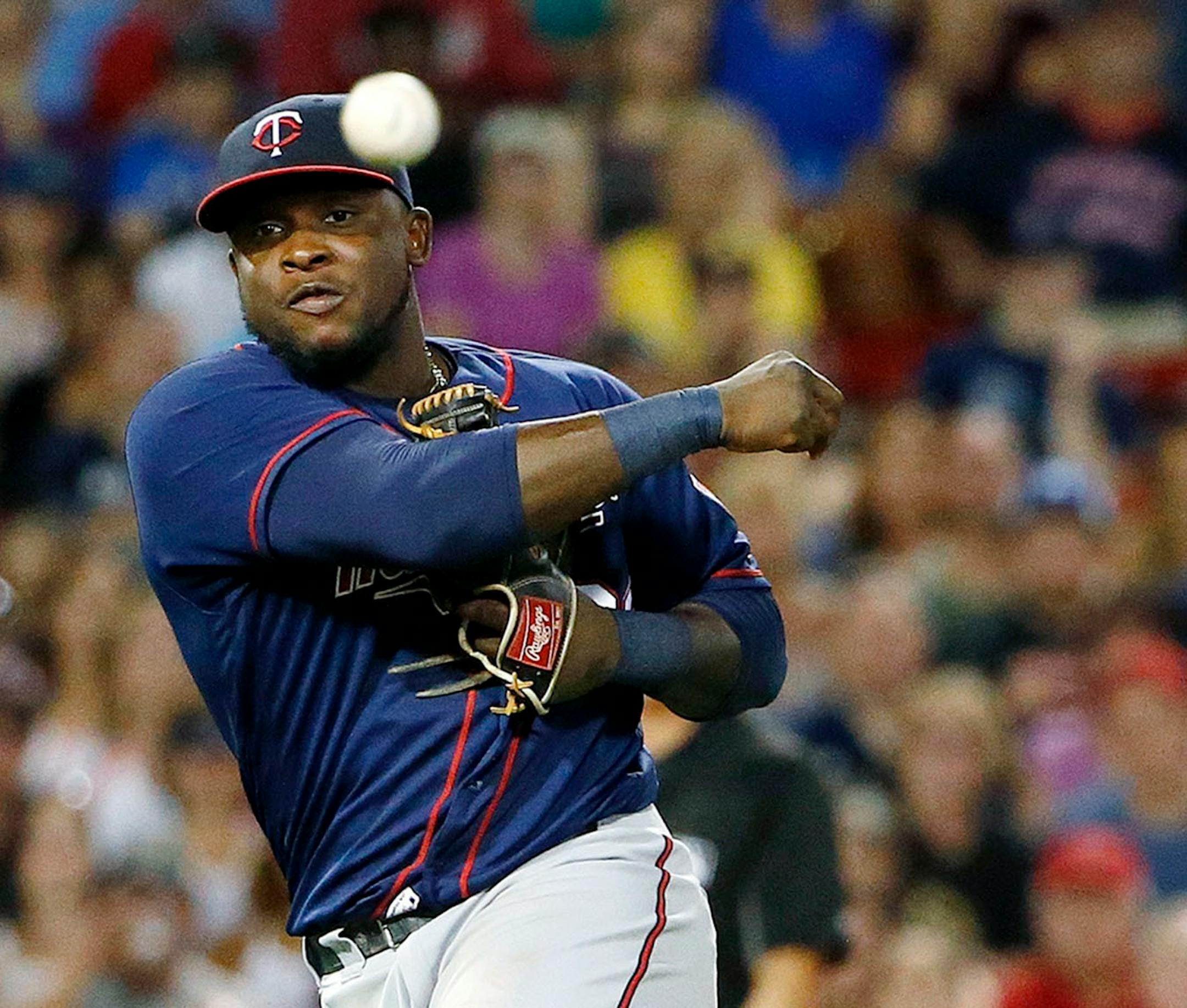 Minnesota Twins' Miguel Sano throws to first base on an infield single by Boston Red Sox's Jackie Bradley Jr. during the sixth inning of a baseball game in Boston, Saturday, July 23, 2016. Sano's throwing error allowed Xander Bogaerts to score.