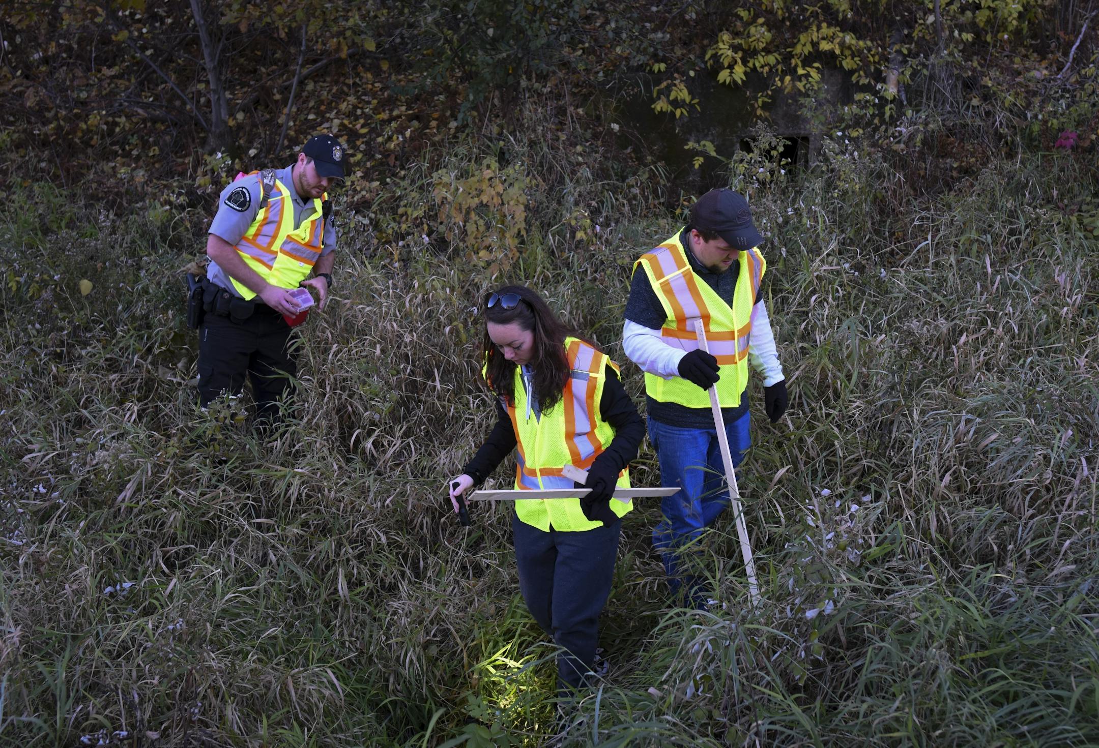 Law enforcement and volunteers searched along Highway 8 in Poskin, Wisc. for evidence related to the disappearance of 13-year old Jayme Closs, and the murder of her parents, on Thursday, Oct. 18, 2018.