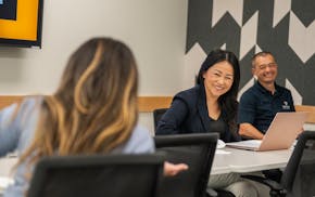 May Yang-Her and husband, Dao Her, owners of DaoTech Solutions, a St. Paul-based tech consulting firm, teach a class on AI marketing to Twin Cities en