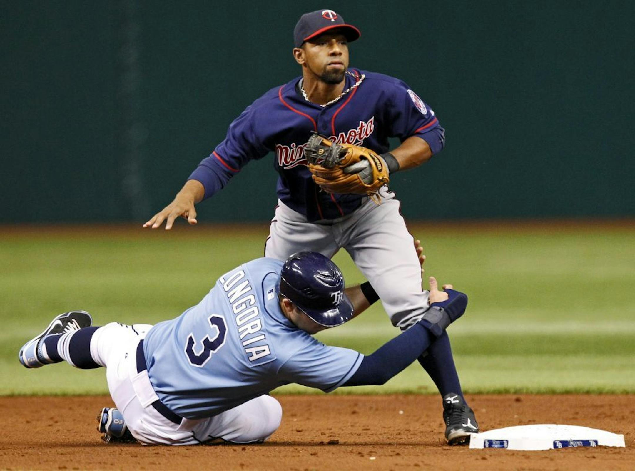 Tampa Bay Rays' Evan Longoria (3) slides into Minnesota Twins' Alexi Casilla in an attempt to break up a double play during the second inning of a baseball game Sunday, April 22, 2012, in St. Petersburg, Fla. B.J. Upton was out at first.