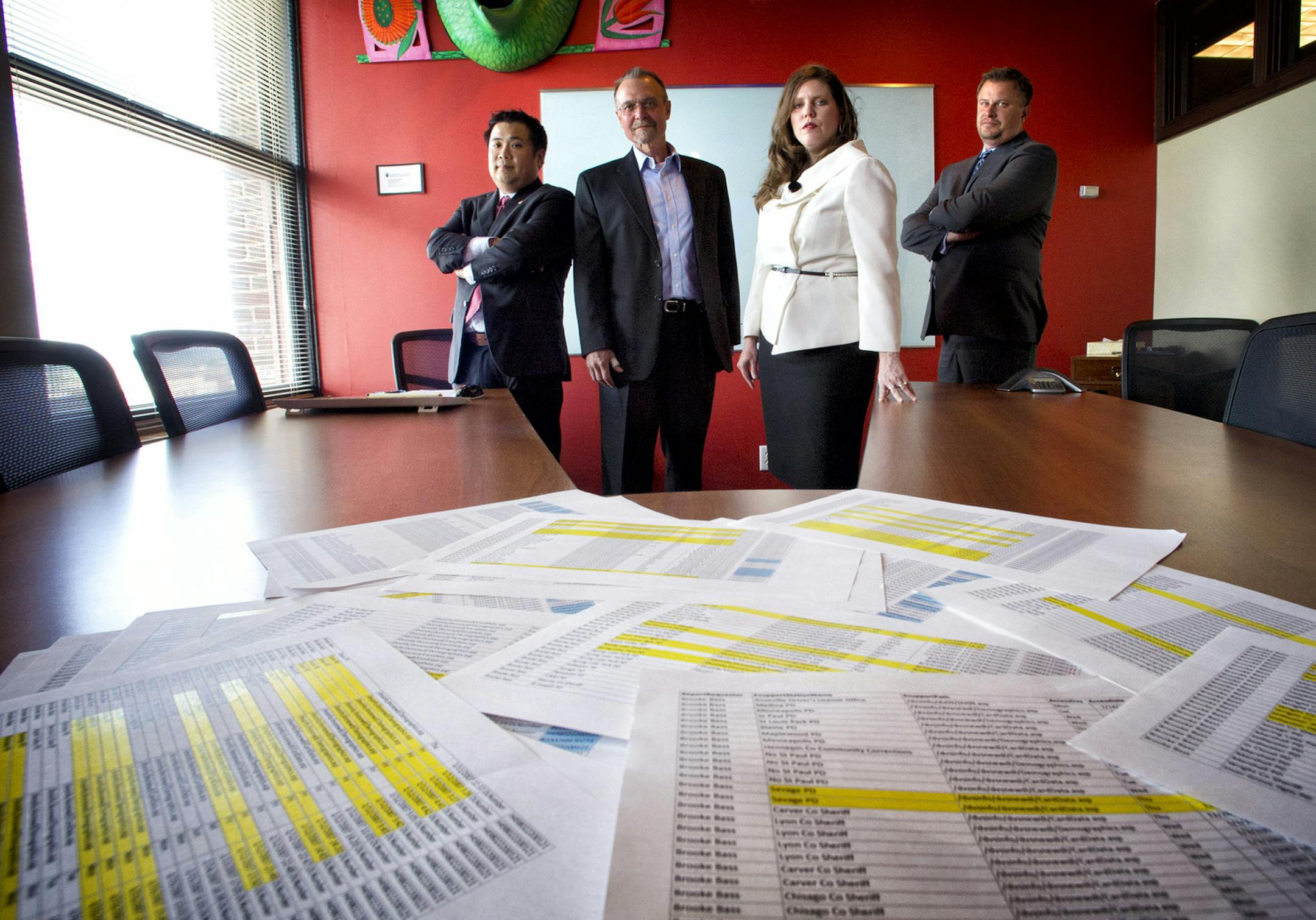 Attorneys from Sapientia Law Group, the primary driver of litigation against local government entities over misuse of the state's drivers license database. L to R Kenn Fukudam Larry Fett, Sonia Miller-Van Oort and Mark Zitzewitz with files from the Brooke Bass case with over 750 lookups on the DVS data system by name only from 2005-2012. Tuesday, August 13, 2013 ] GLEN STUBBE * gstubbe@startribune.com