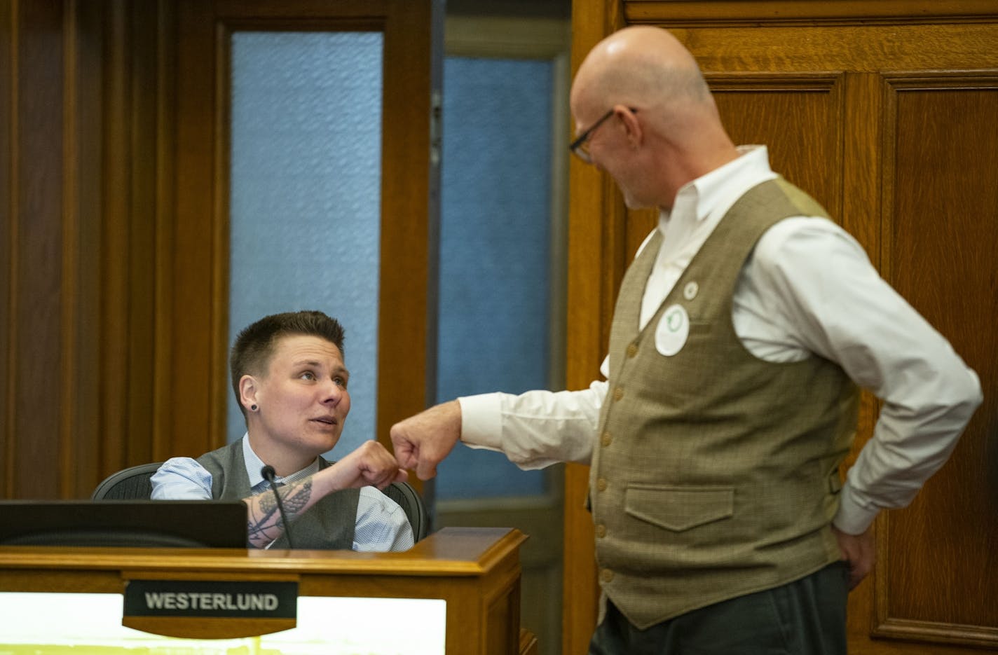 Duluth City councilors Em Westerlund, left, and Gary Anderson fist bumped before their session on Monday December 16, 2019.