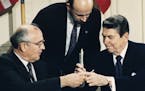 FILE - In this Dec. 8, 1987 file photo U.S. President Ronald Reagan, right, and Soviet leader Mikhail Gorbachev exchange pens during the Intermediate 