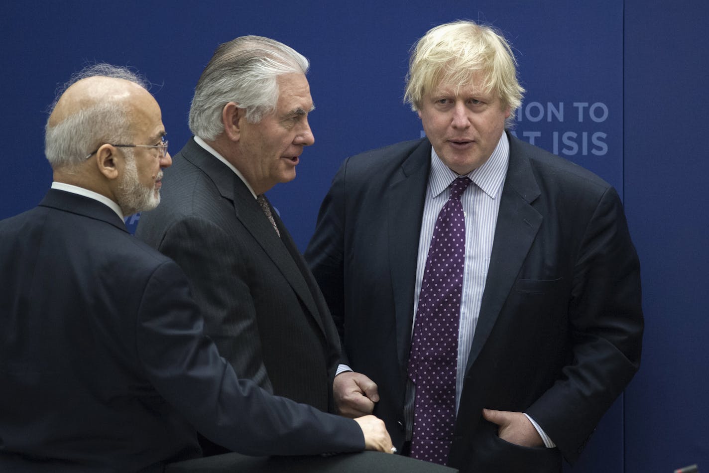 Secretary of State Rex Tillerson, center, talks with British Foreign Minister Boris Johnson, right and Iraqi Foreign Minister Ibrahim Jafari, left, during the Meeting of the Ministers of the Global Coalition on the Defeat of ISIS, Wednesday, March 22, 2017, at the State Department in Washington. Top officials from the 68-nation coalition fighting the Islamic State group are looking to increase pressure on the group as U.S.-backed forces move closer to retaking Mosul. (AP Photo/Cliff Owen)