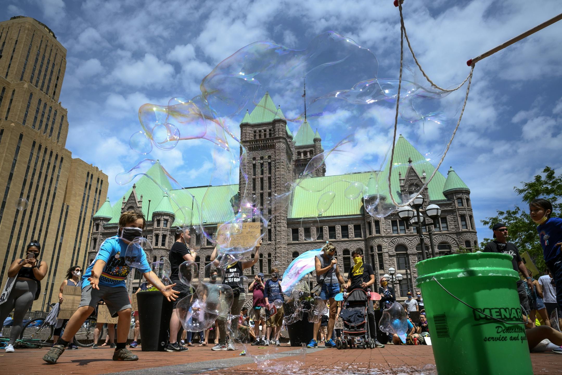 Children played with bubbles outside the Hennepin County Government Center while waiting for Saturdays' "International Solidarity Day of Protest Against Police Terror" rally to start.