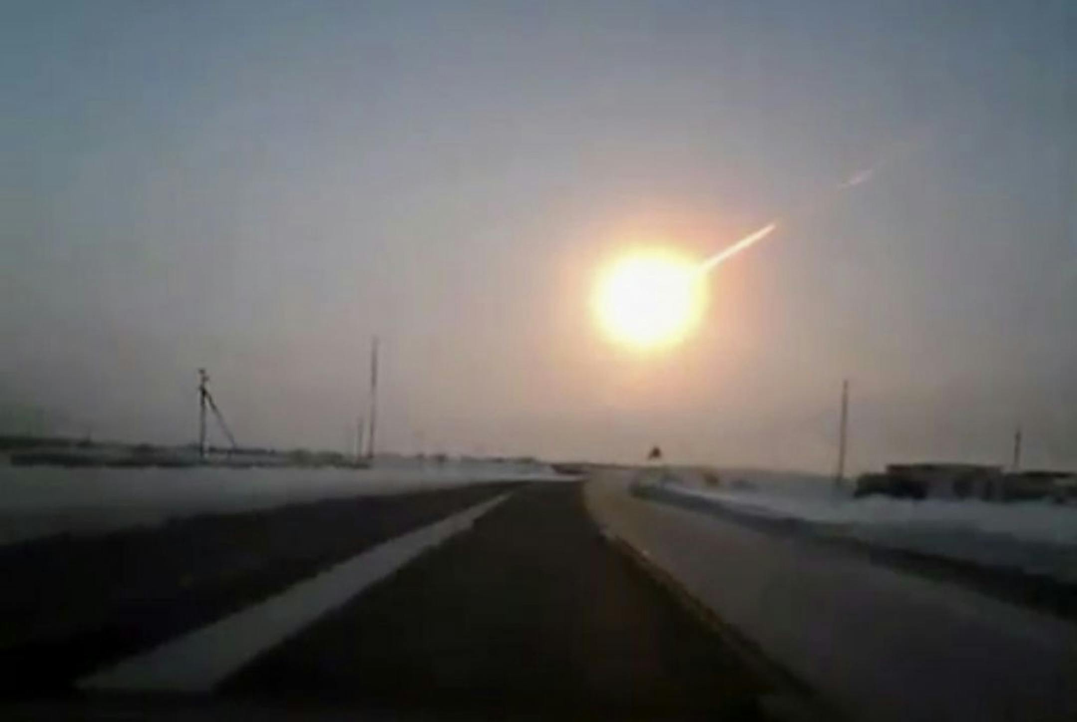 In this frame grab made from a video done with a dashboard camera, on a highway from Kostanai, Kazakhstan, to Chelyabinsk region, Russia, provided by Nasha Gazeta newspaper, on Friday, Feb. 15, 2013 a meteorite contrail is seen. A meteor streaked across the sky of Russia's Ural Mountains on Friday morning, causing sharp explosions and reportedly injuring around 100 people, including many hurt by broken glass.