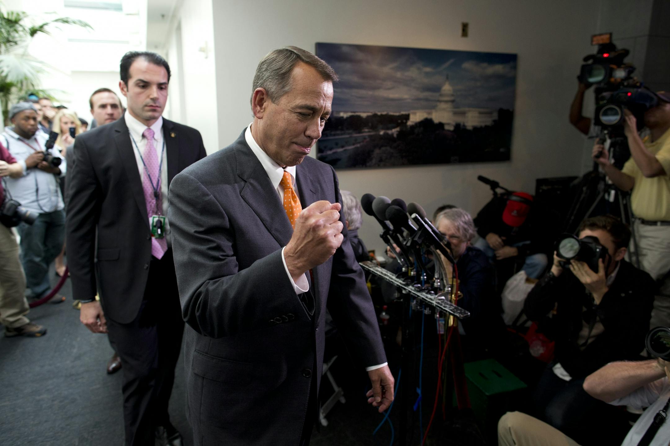 Speaker of the House Rep. John Boehner, R-Ohio, pumps his fist as he walks past reporters after a meeting with House Republicans on Capitol Hill on Wednesday, Oct. 16, 2013 in Washington.