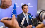Greek Prime Minister Alexis Tsipras speaks with the media after a meeting of eurozone heads of state at the EU Council building in Brussels on Monday,