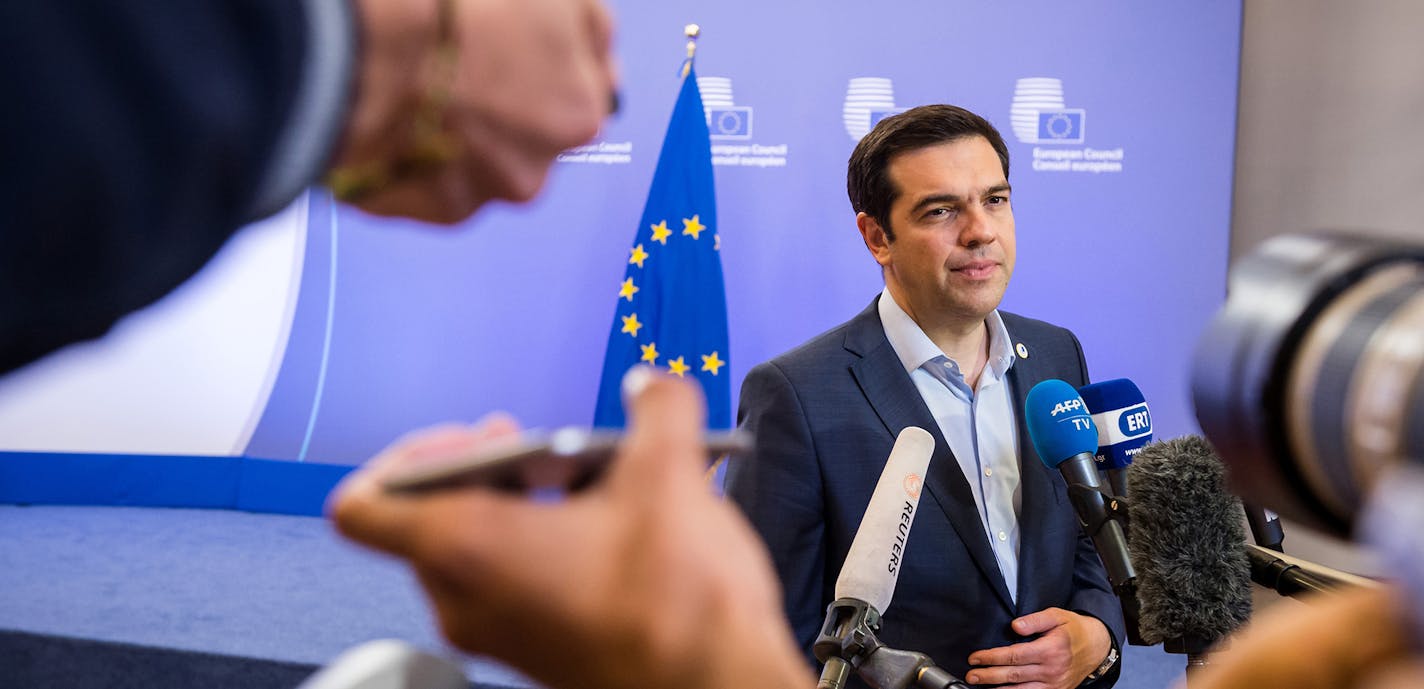 Greek Prime Minister Alexis Tsipras speaks with the media after a meeting of eurozone heads of state at the EU Council building in Brussels on Monday, July 13, 2015. A summit of eurozone leaders reached a tentative agreement with Greece on Monday for a bailout program that includes "serious reforms" and aid, removing an immediate threat that Greece could collapse financially and leave the euro. (AP Photo/Geert Vanden Wijngaert) ORG XMIT: MIN2015071314022729