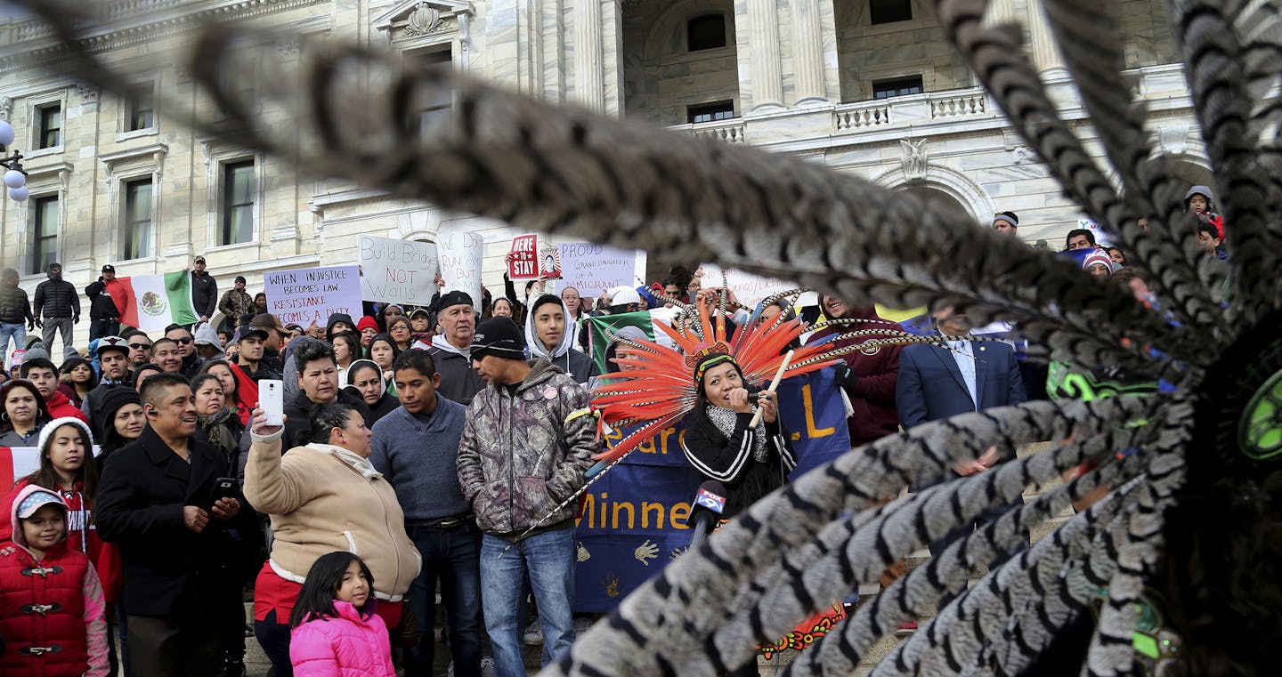 Participants in the "Day Without Immigrants," including members of Mexica Yolotl, a traditional Aztec group of Mexico-American dancers and drummers from the Twin Cities, fill the steps outside the Minnesota State Capitol Thursday, Feb. 16, 2017, in St. Paul, Minn. Immigrants around the U.S. stayed home from work and school Thursday to demonstrate how important they are to America&#xed;s economy and way of life, and many businesses closed in solidarity, in a nationwide protest called A Day Withou