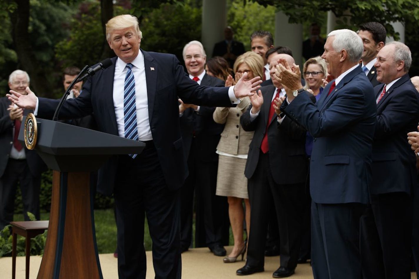 President Donald Trump, accompanied by GOP House members, speaks in the Rose Garden of the White House in Washington, Thursday, May 4, 2017, after the House pushed through a health care bill.