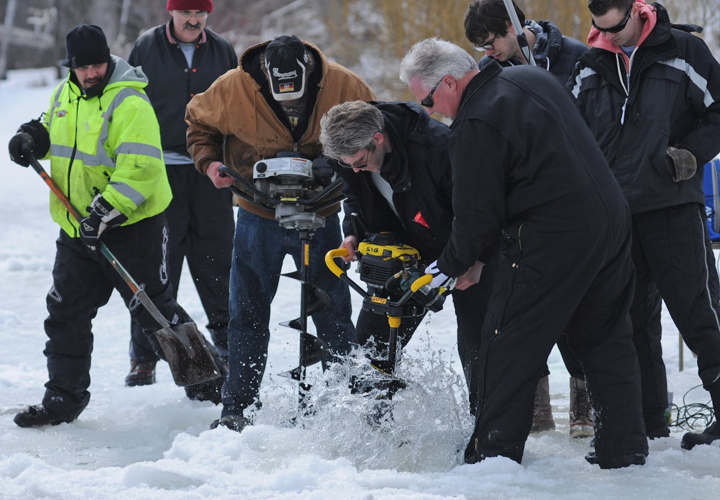 Kira Trevino's cousin, Mike Teige, is taking matters into his own hands. He showed up at Keller Lake on Friday morning to do his own drilling and search. Mike Teige, in the center in brown with a group of volunteers cut a six foot hole through the lake where one of the underwater cameras found what they thought could be a tarp. ] Richard.Sennott@startribune.com Richard Sennott/Star Tribune. , Maplewood Minn. Friday 3/29/13) ** (cq)