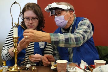 Caleb Ihla gets help from his grandfather Rod Basham as he fixed a lamp during a Ramsey County fix-it clinic Saturday, Nov. 19, 2022 at the Ramsey Cou